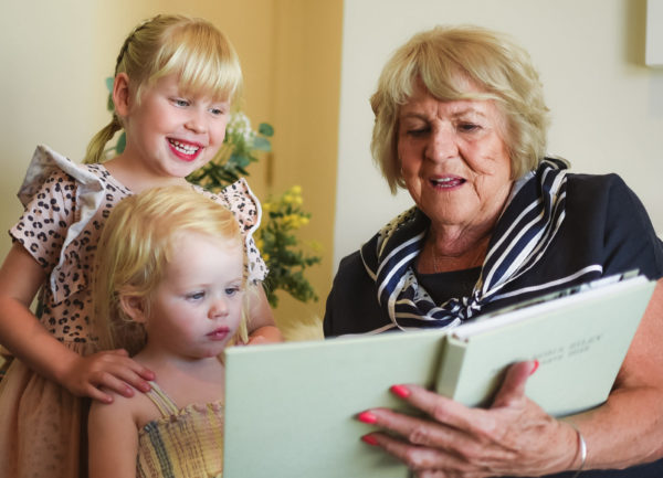 Grandmother reading to Grandchildren on Mothers Day at The Richardson aged care