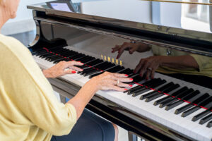 Elderly woman playing music on the piano